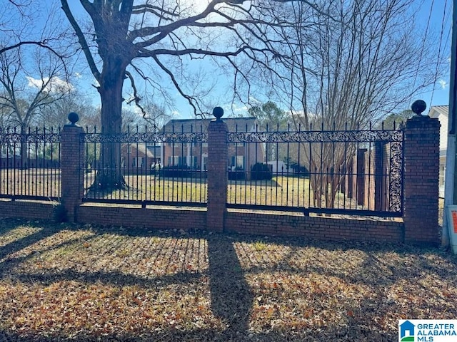 view of gate featuring a yard