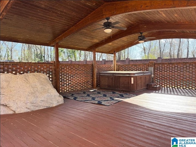 wooden deck featuring ceiling fan and a hot tub