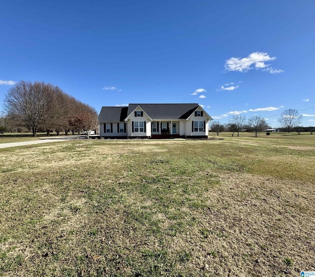 view of front of house featuring a rural view and a front lawn