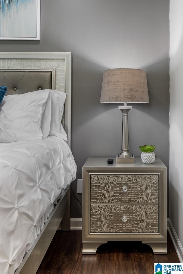 bedroom with dark hardwood / wood-style floors