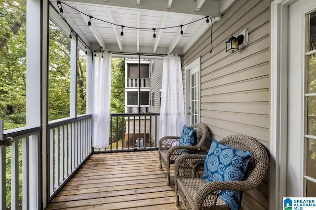 sunroom with beamed ceiling and wooden ceiling