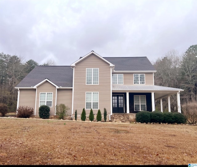 view of front of home featuring covered porch and a front lawn