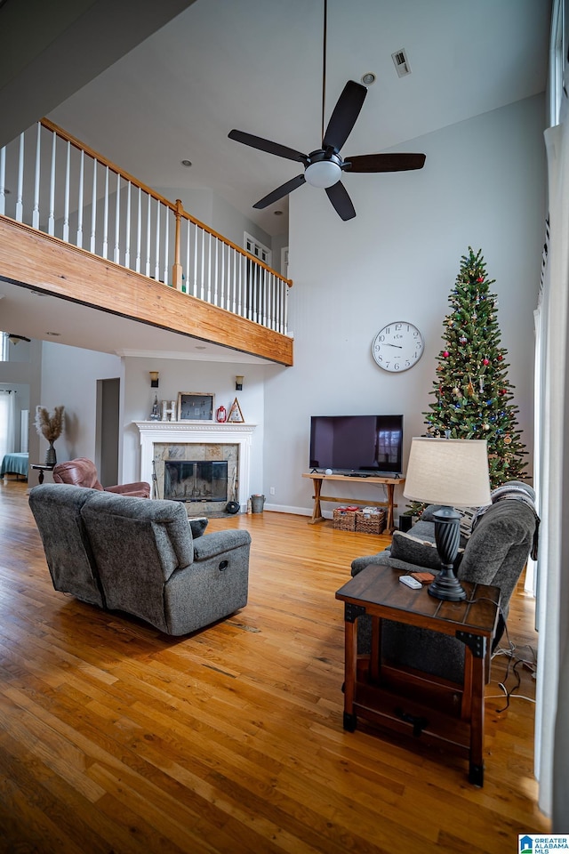 living room with ceiling fan and wood-type flooring