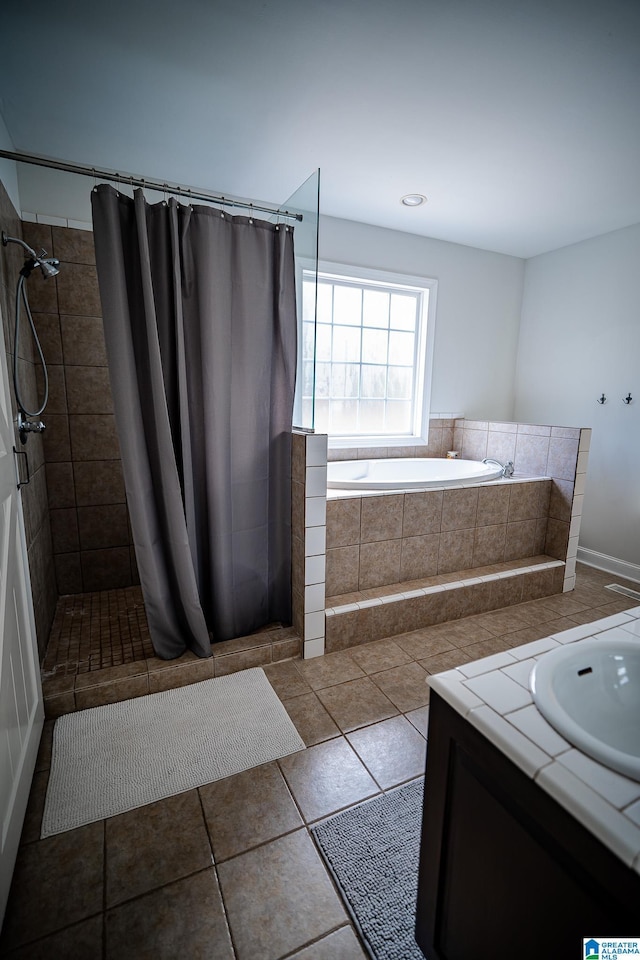 bathroom featuring tile patterned flooring, vanity, and plus walk in shower