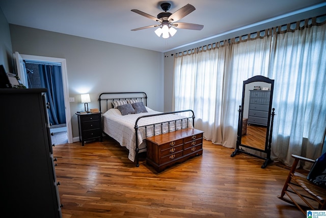 bedroom with dark hardwood / wood-style floors and ceiling fan