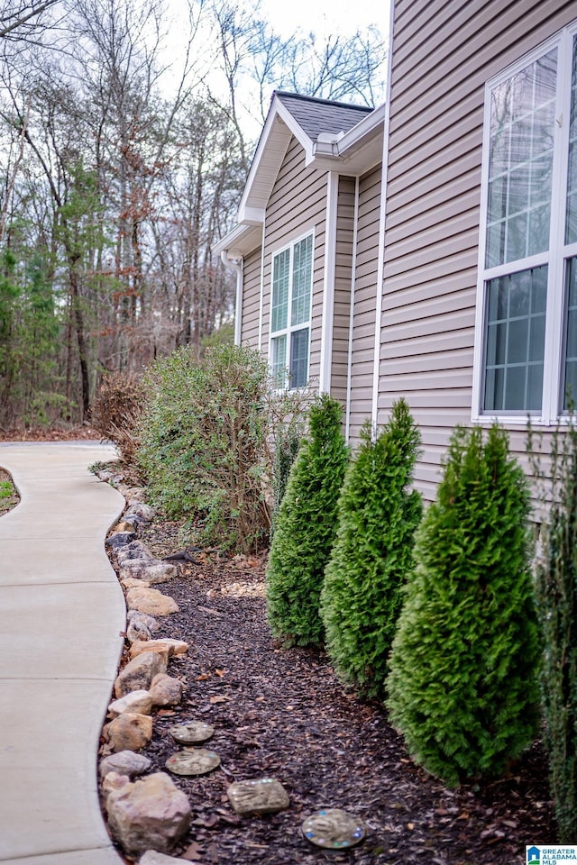 view of side of property with a shingled roof