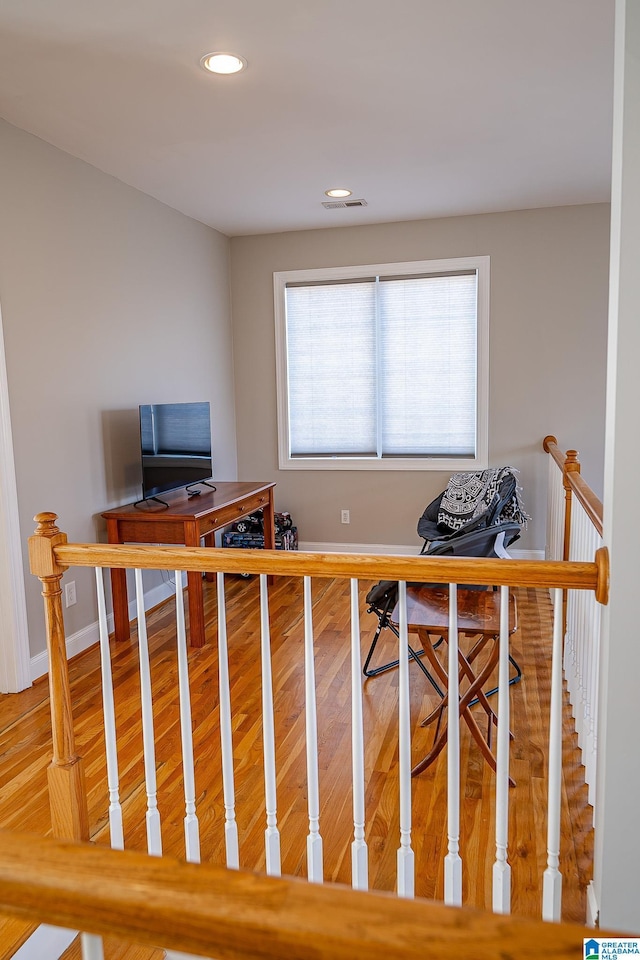 office featuring wood finished floors, recessed lighting, visible vents, and baseboards