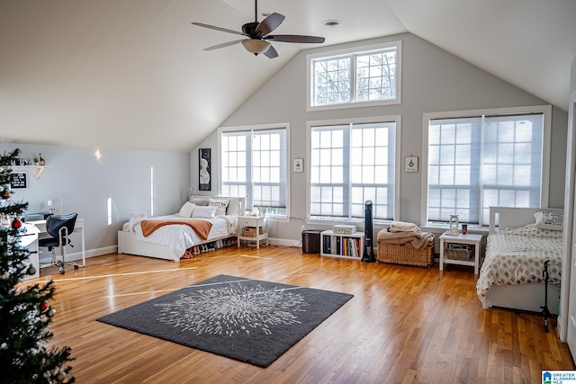 bedroom featuring multiple windows, ceiling fan, and wood-type flooring