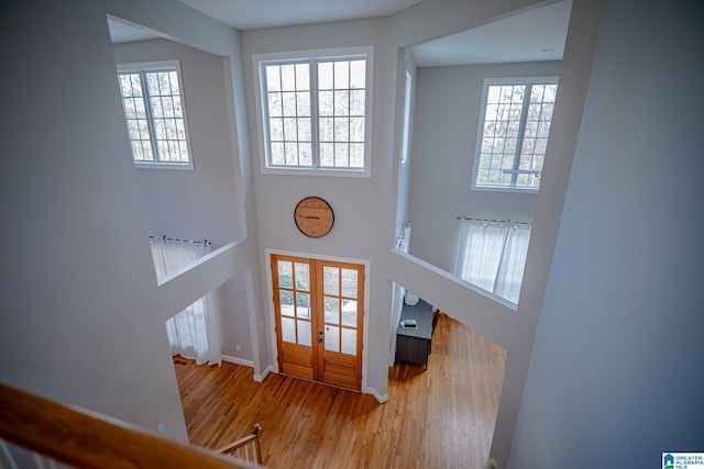 foyer entrance featuring french doors and hardwood / wood-style flooring