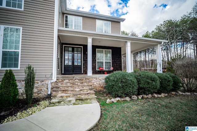 view of exterior entry with covered porch