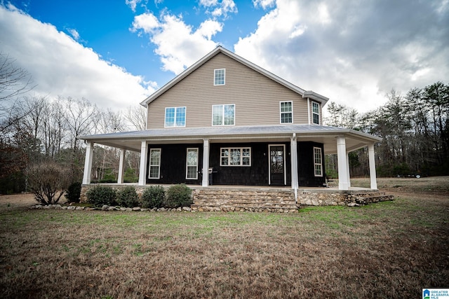 farmhouse-style home with a porch and a front yard