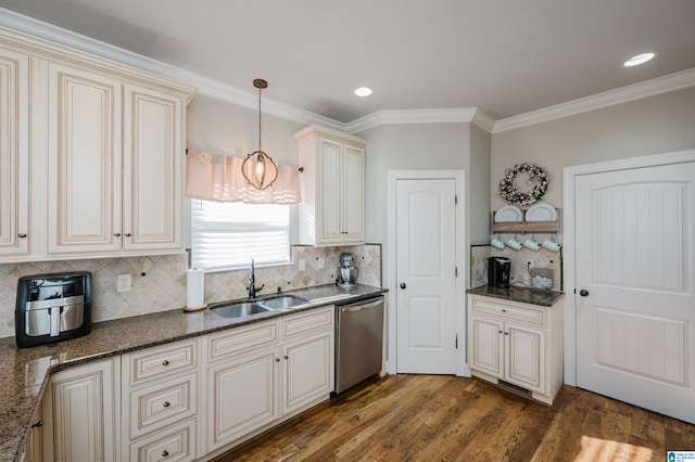 kitchen with dishwasher, backsplash, cream cabinets, sink, and ornamental molding