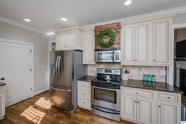 kitchen featuring decorative backsplash, appliances with stainless steel finishes, dark hardwood / wood-style floors, and ornamental molding