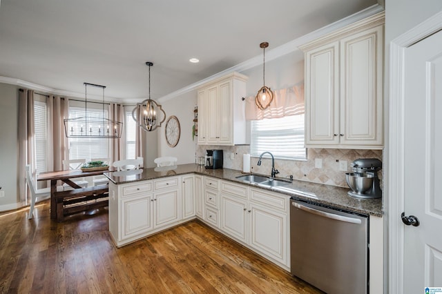 kitchen with kitchen peninsula, decorative light fixtures, dishwasher, and sink