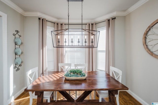 dining area featuring hardwood / wood-style flooring and crown molding