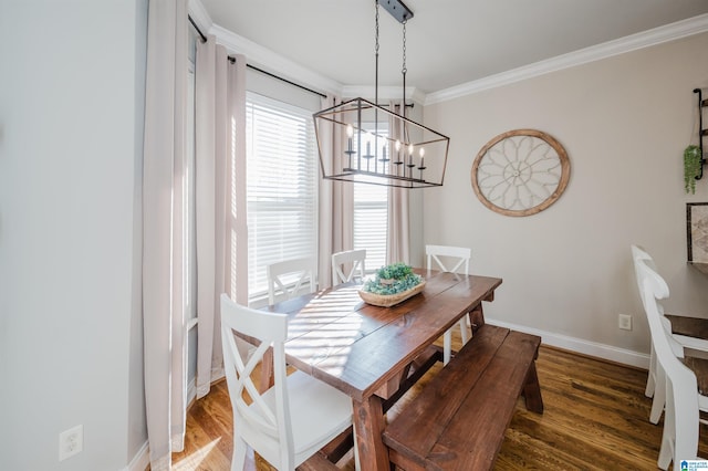 dining space with an inviting chandelier, crown molding, and dark wood-type flooring