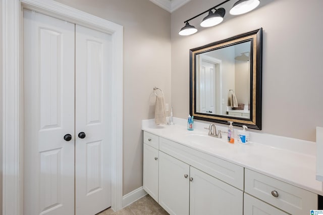 bathroom with tile patterned floors, vanity, and ornamental molding