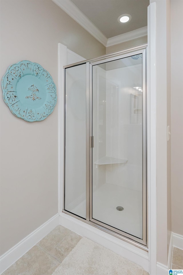 bathroom with tile patterned flooring, an enclosed shower, and crown molding