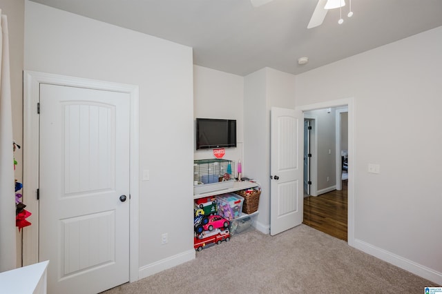 bedroom featuring ceiling fan and light carpet