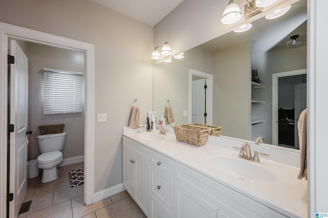 bathroom with tile patterned floors, vanity, and toilet