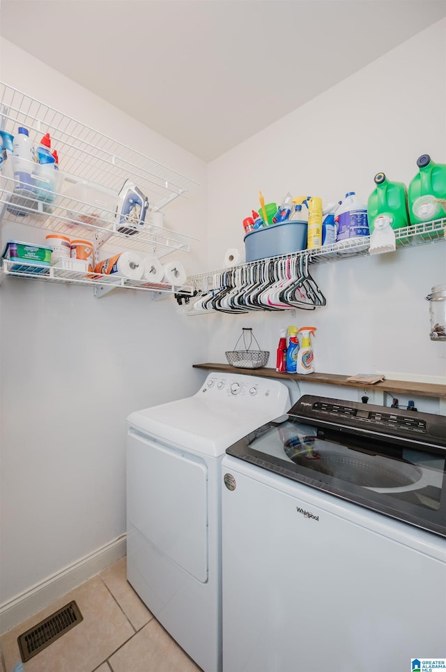 washroom featuring washing machine and clothes dryer and light tile patterned floors