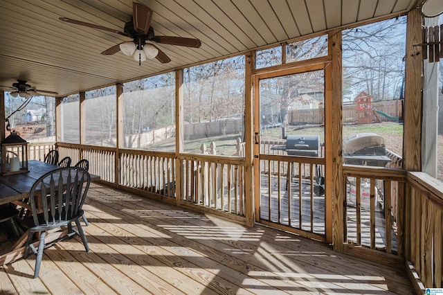 unfurnished sunroom with a wealth of natural light, wooden ceiling, and ceiling fan