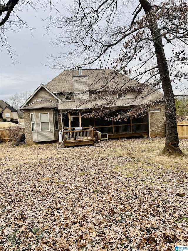 rear view of property featuring a wooden deck