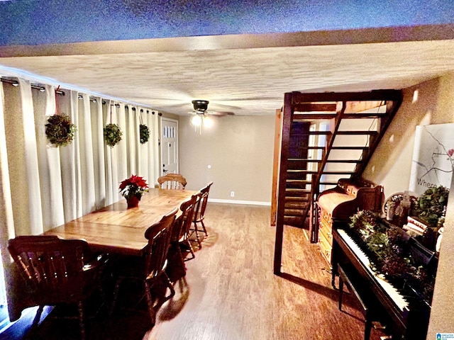 dining area featuring hardwood / wood-style flooring and ceiling fan