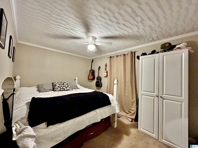 carpeted bedroom with ceiling fan and crown molding