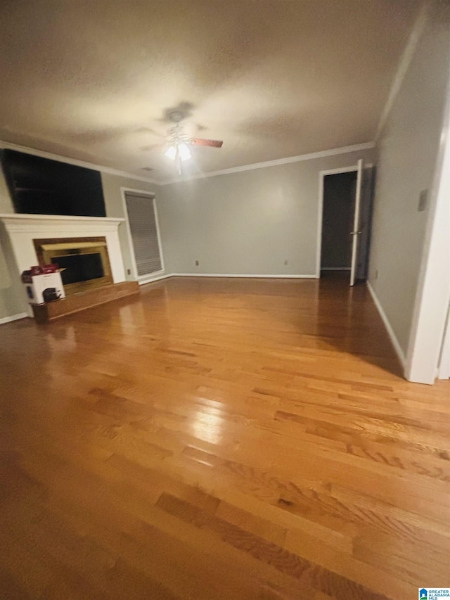 unfurnished living room featuring crown molding, hardwood / wood-style floors, and ceiling fan