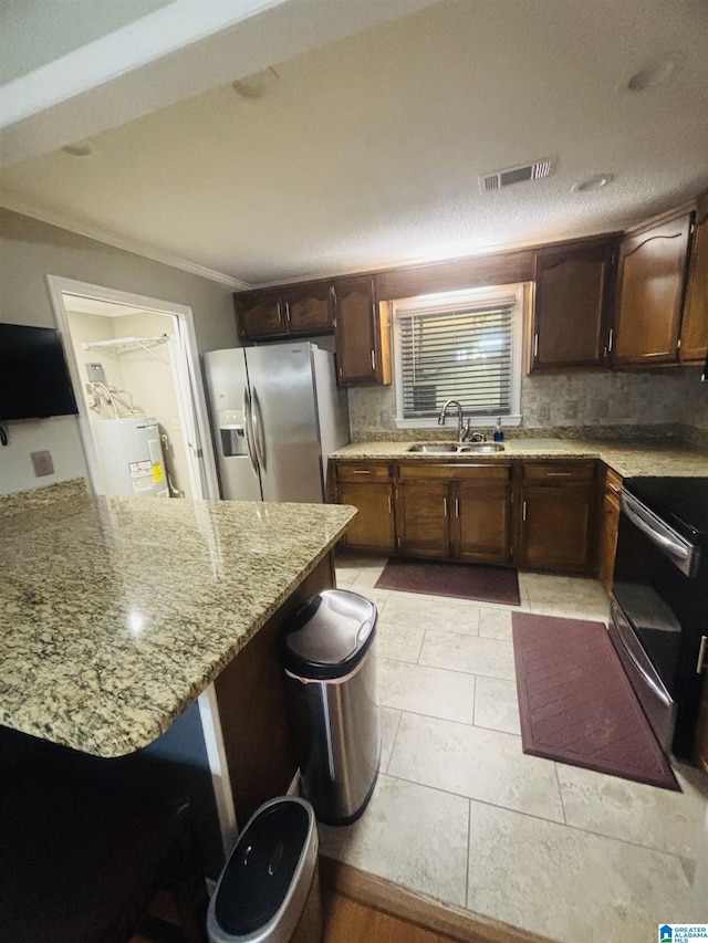 kitchen featuring light stone counters, stainless steel appliances, crown molding, sink, and washer / dryer