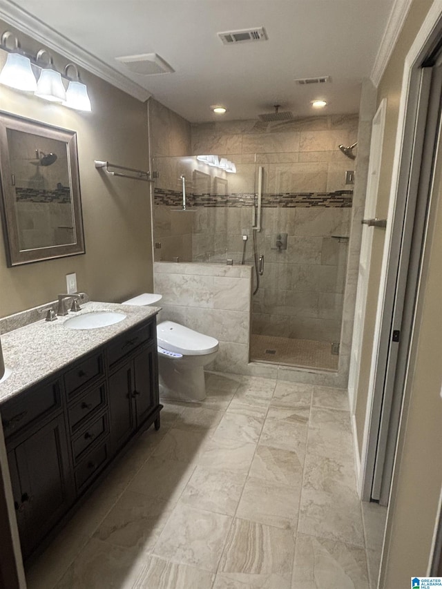 bathroom featuring toilet, vanity, a shower with door, and ornamental molding