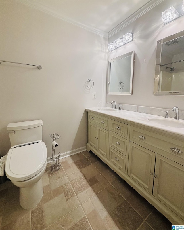 bathroom with crown molding, vanity, and toilet