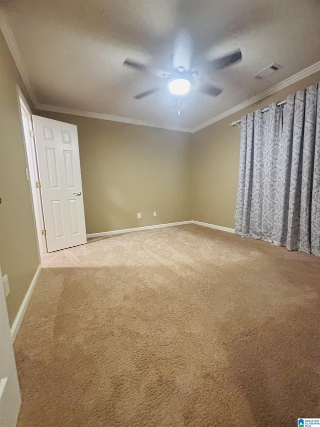 spare room with carpet flooring, ceiling fan, and crown molding