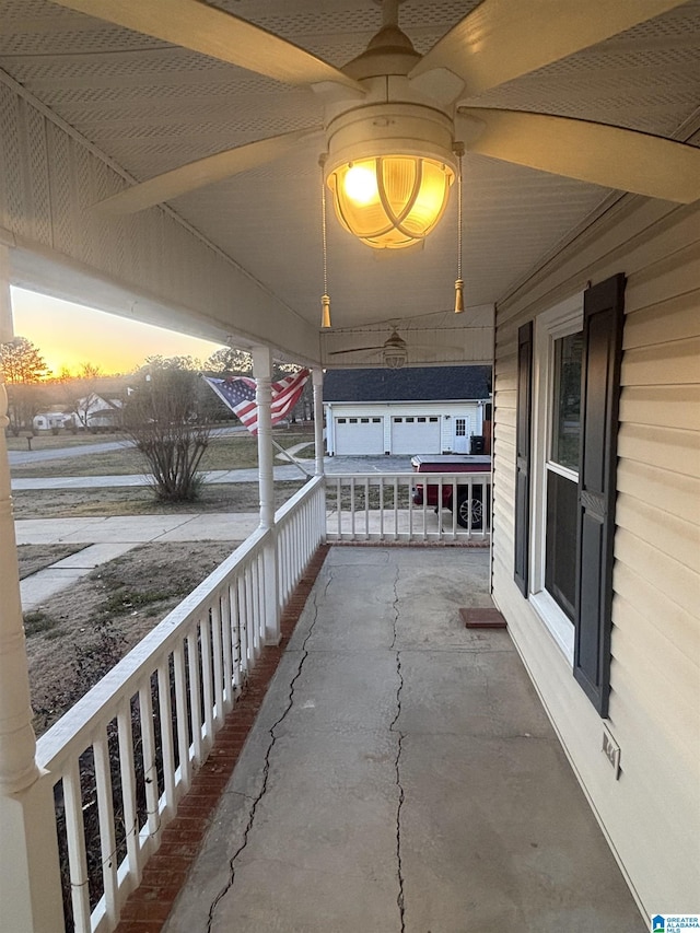 patio terrace at dusk featuring a porch