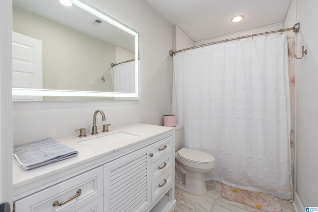 bathroom featuring vanity and toilet