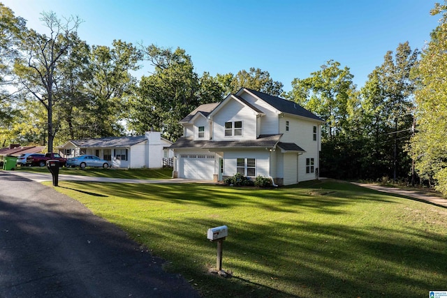 view of front of home with a garage and a front lawn