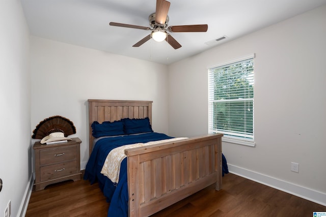 bedroom with ceiling fan and dark wood-type flooring