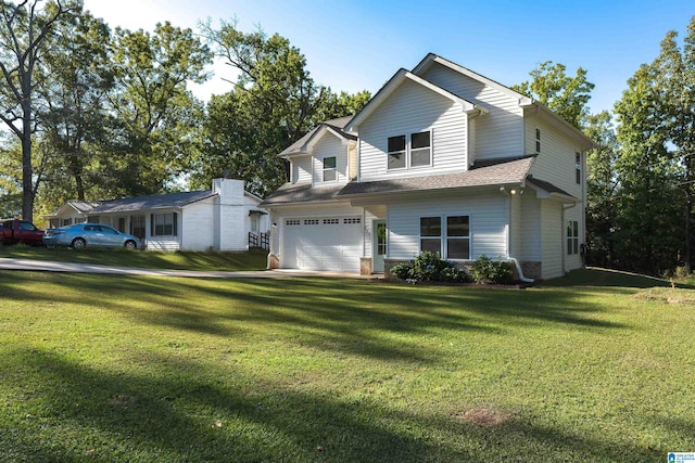 view of front of home with a garage and a front lawn