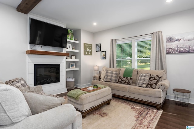 living room with a fireplace, wood-type flooring, and beam ceiling