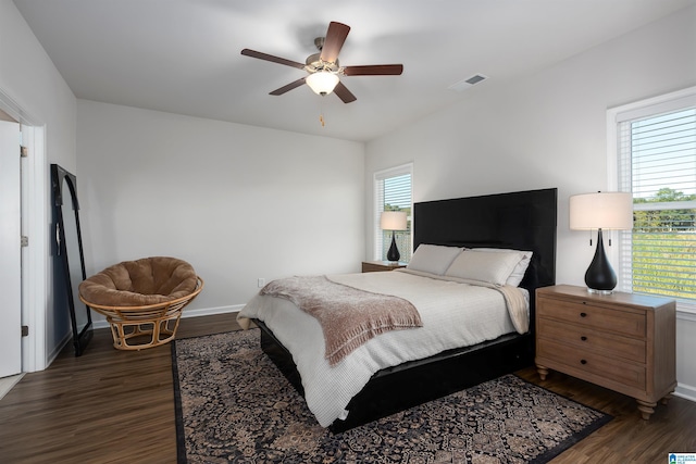 bedroom with ceiling fan and dark hardwood / wood-style flooring