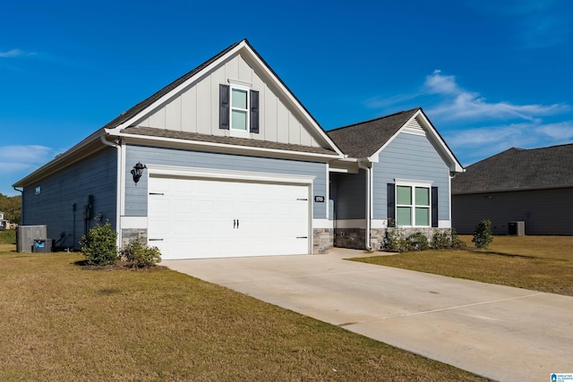 craftsman-style house featuring cooling unit, a front yard, and a garage