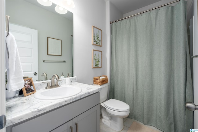 bathroom with tile patterned flooring, vanity, and toilet