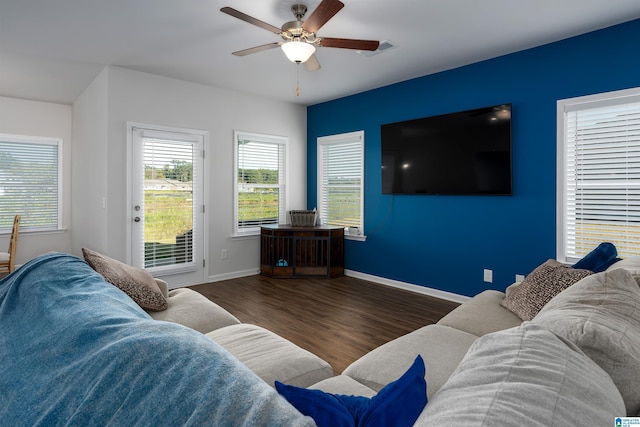 living room with ceiling fan and dark wood-type flooring