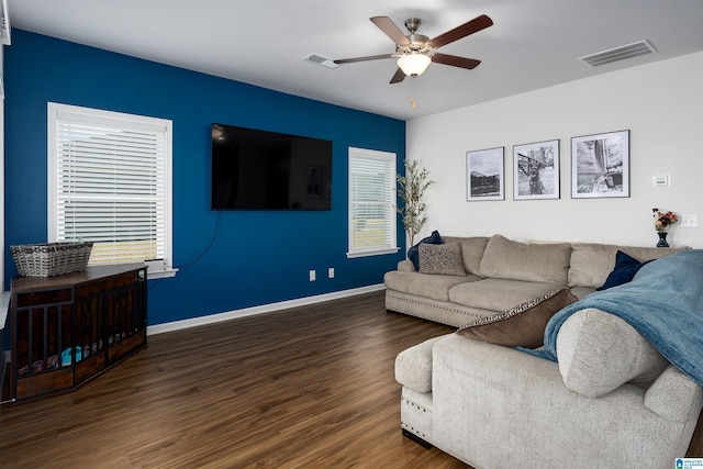 living room with dark hardwood / wood-style floors and ceiling fan