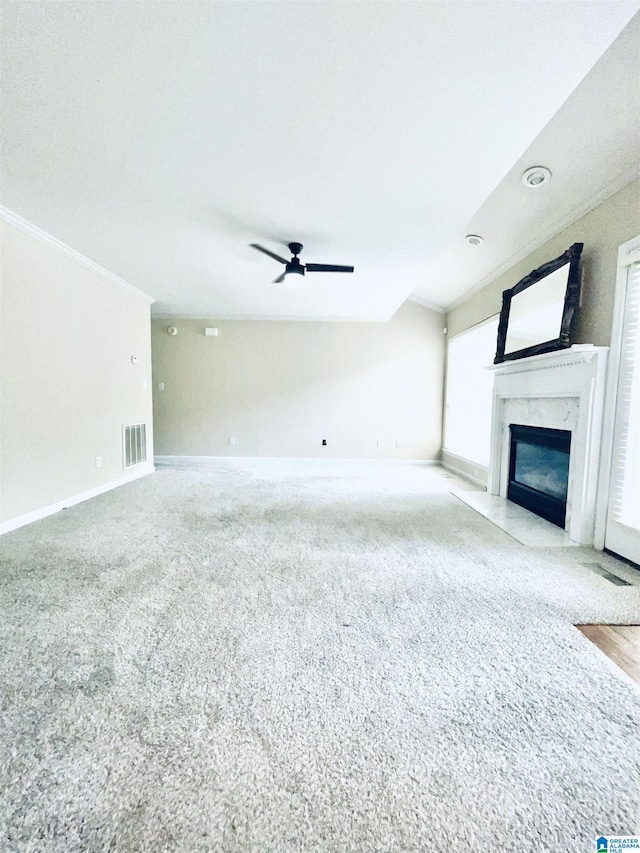 unfurnished living room featuring ceiling fan and a high end fireplace