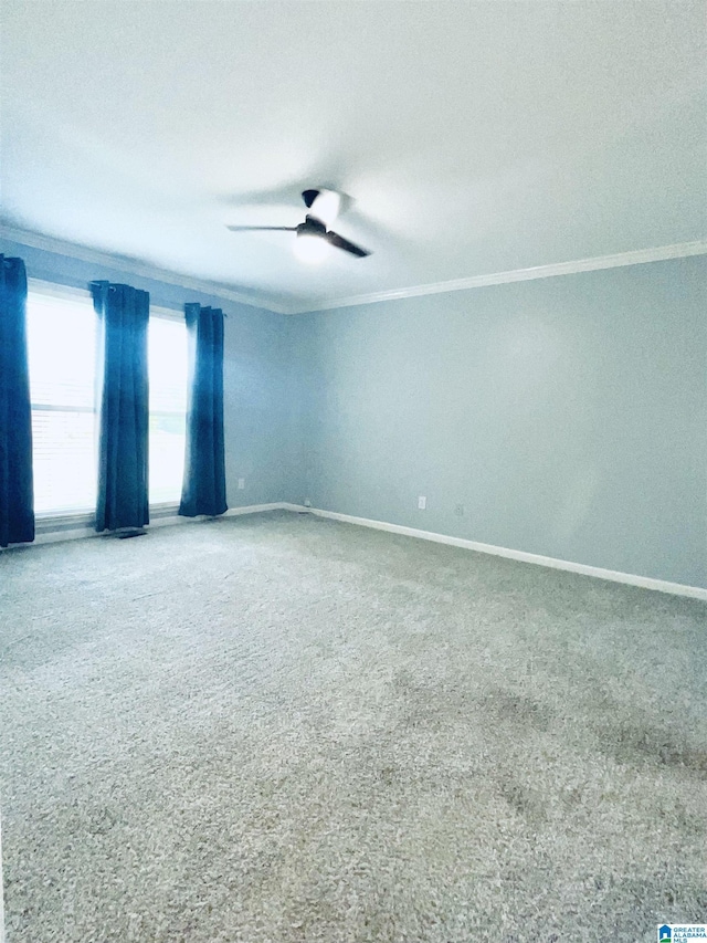 unfurnished room with ceiling fan and ornamental molding