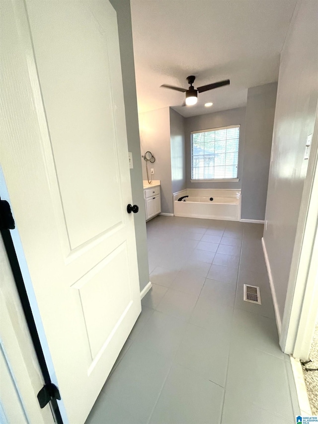 hall with light tile patterned floors