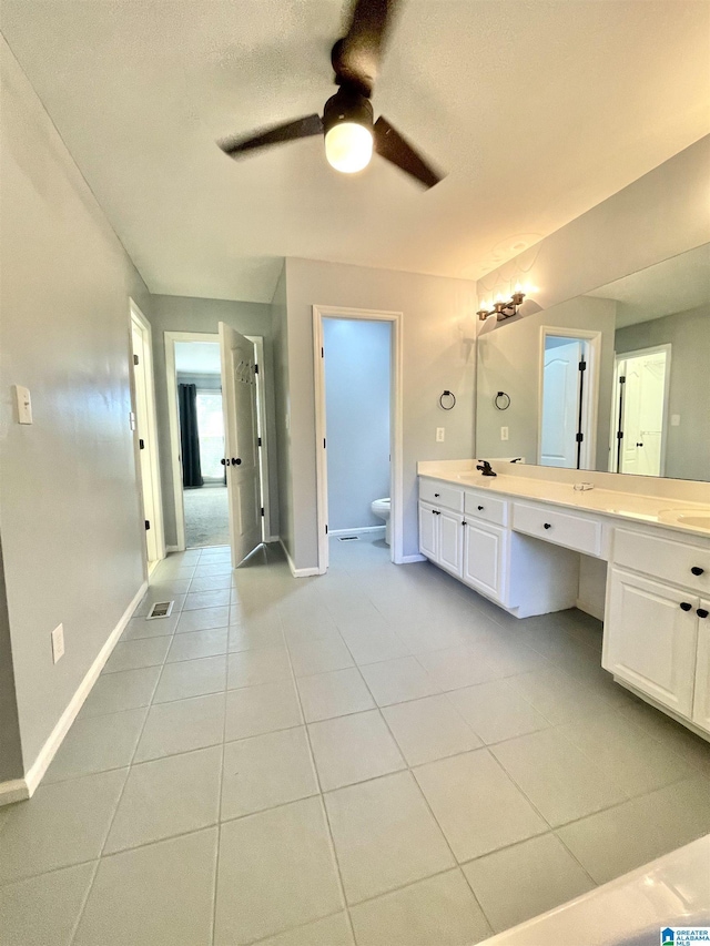 bathroom featuring ceiling fan, tile patterned flooring, vanity, and toilet