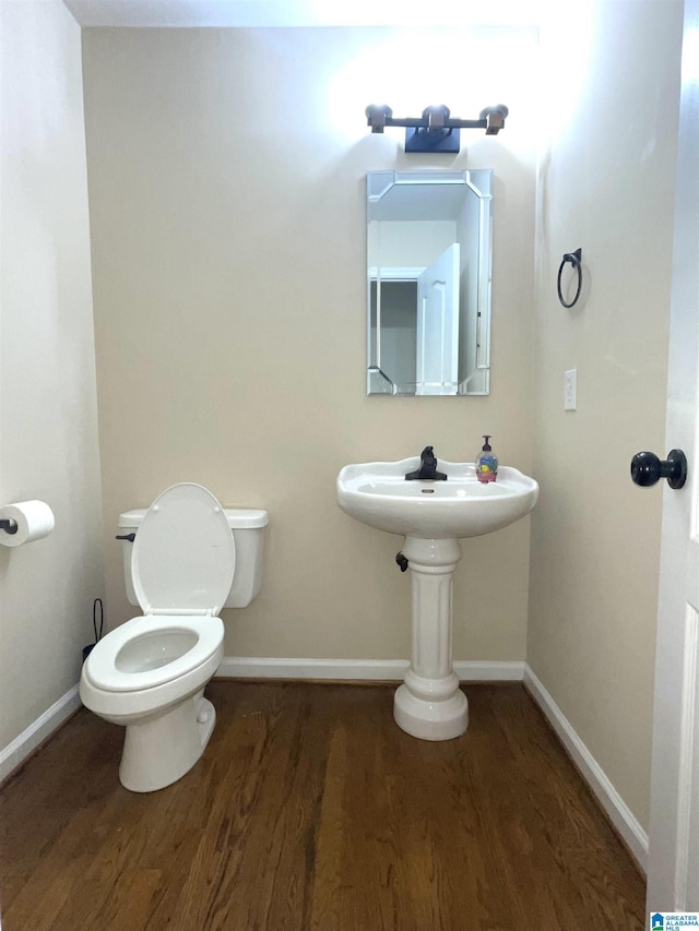 bathroom featuring wood-type flooring and toilet